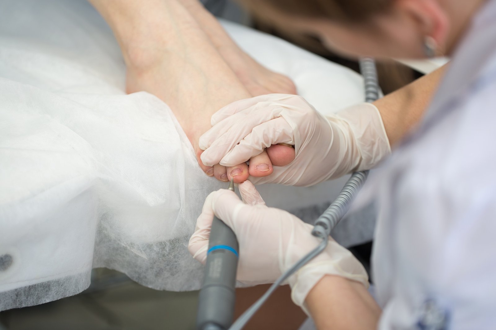 Professional pedicure master making pedicure in salon